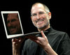 steve jobs holding a macbook air